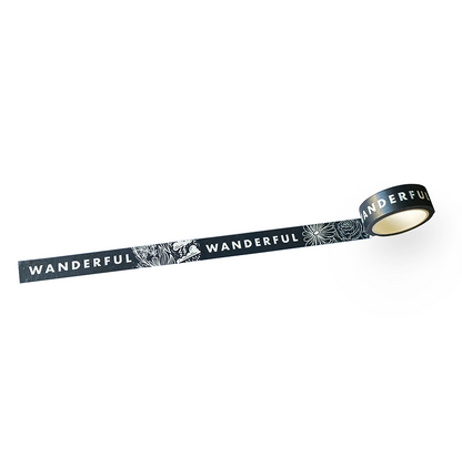 Washi tape roll with dark blue strip, moon-and-flower pattern and WANDERFUL text