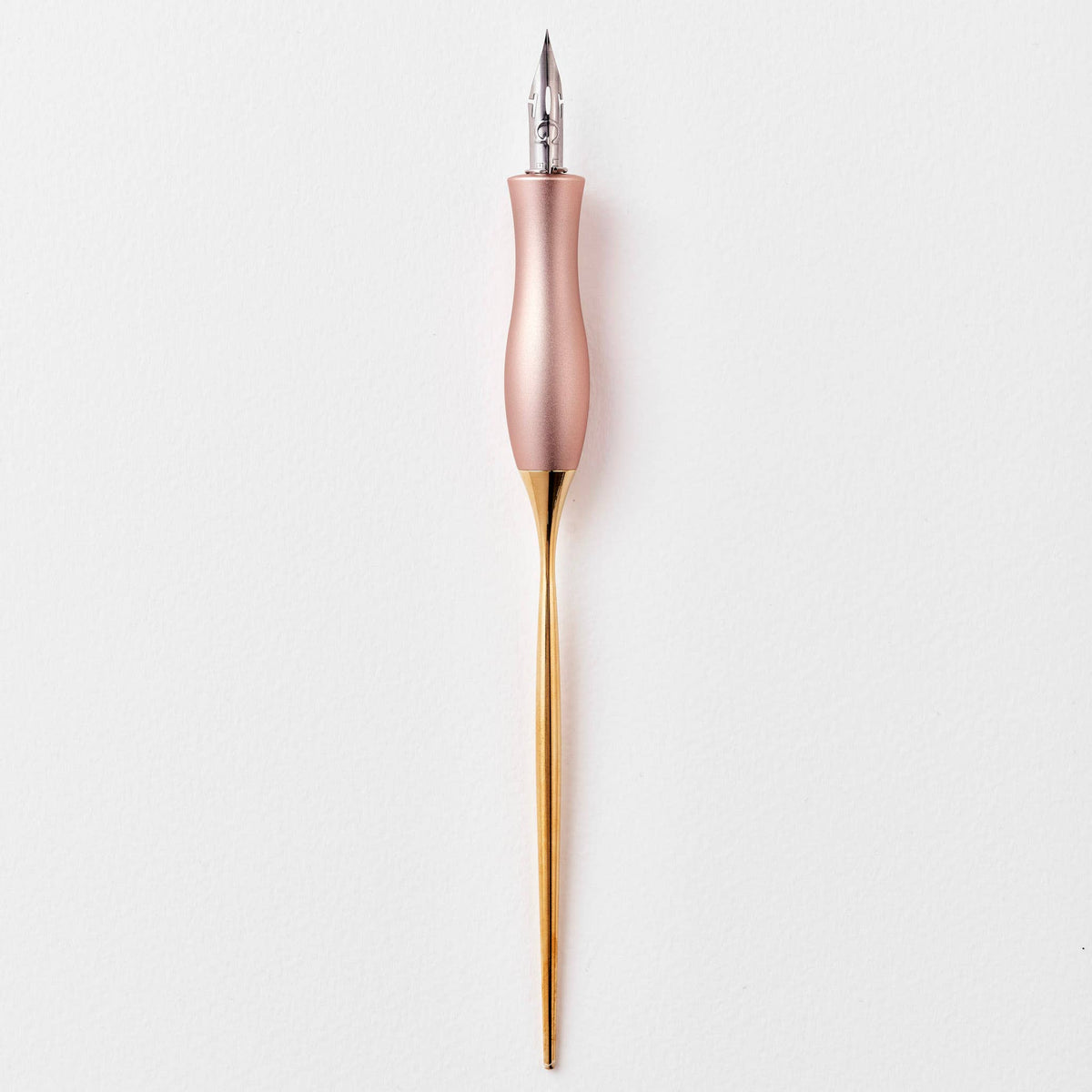 Pink calligraphy pen with oblique nib and gold accents, upright view