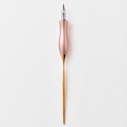 Pink calligraphy pen with oblique nib and gold accents, upright view