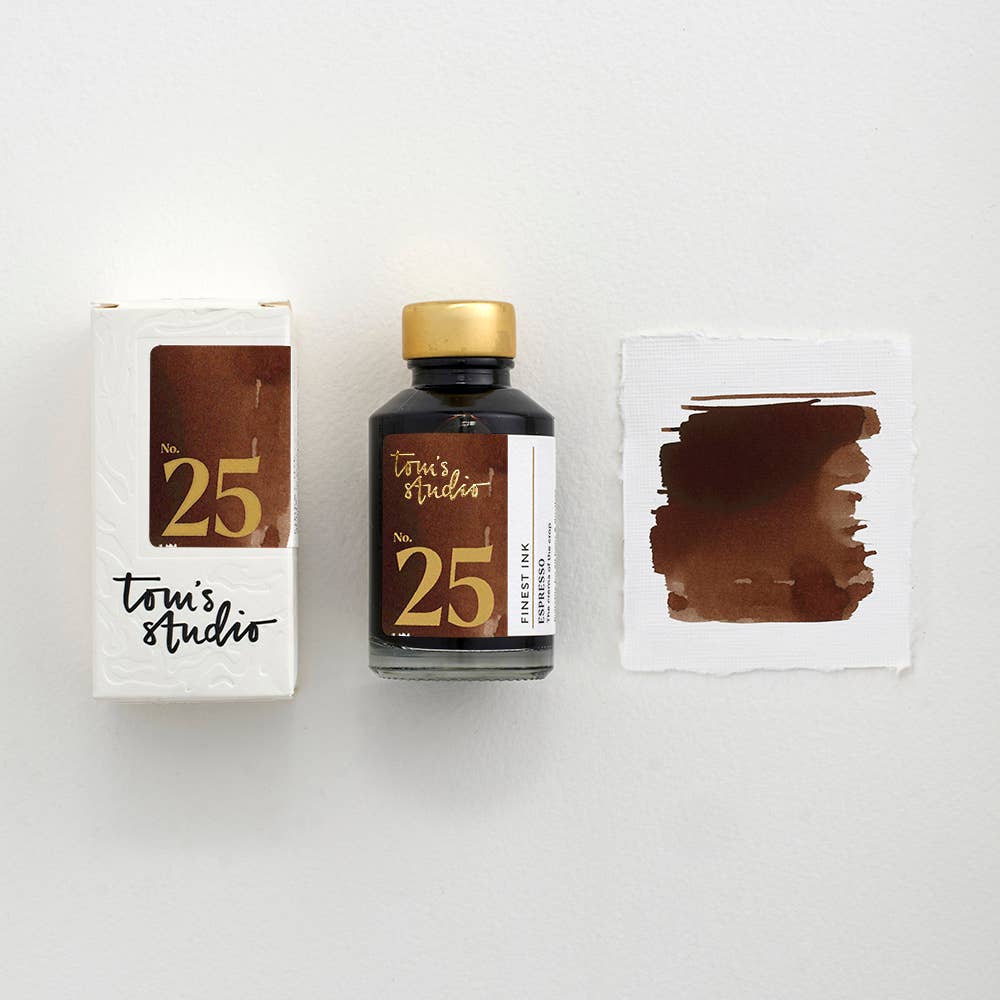 Fountain pen ink bottle with gold cap and brown espresso ink, plus ink sample card