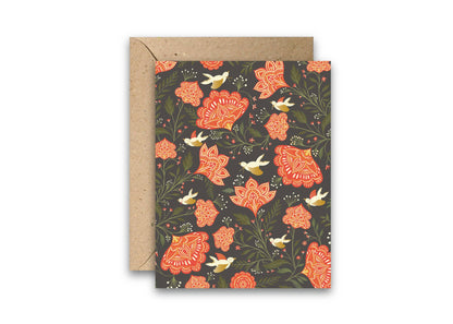 Holiday card with red floral patterns, white doves, and a kraft paper envelope.