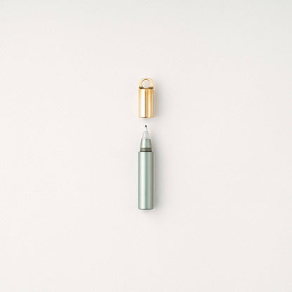 Sage refillable travel pen with open gold cap and slim gray tip