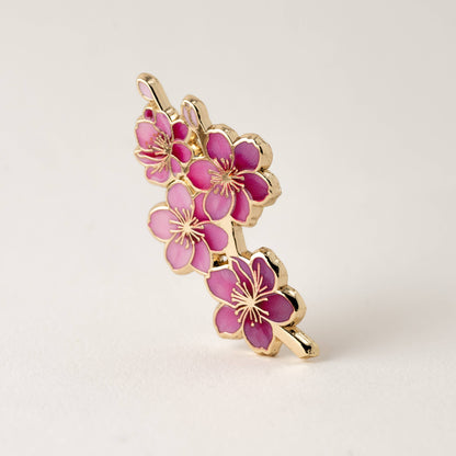Pink cherry blossom enamel pin with gold-tone petals and pin back