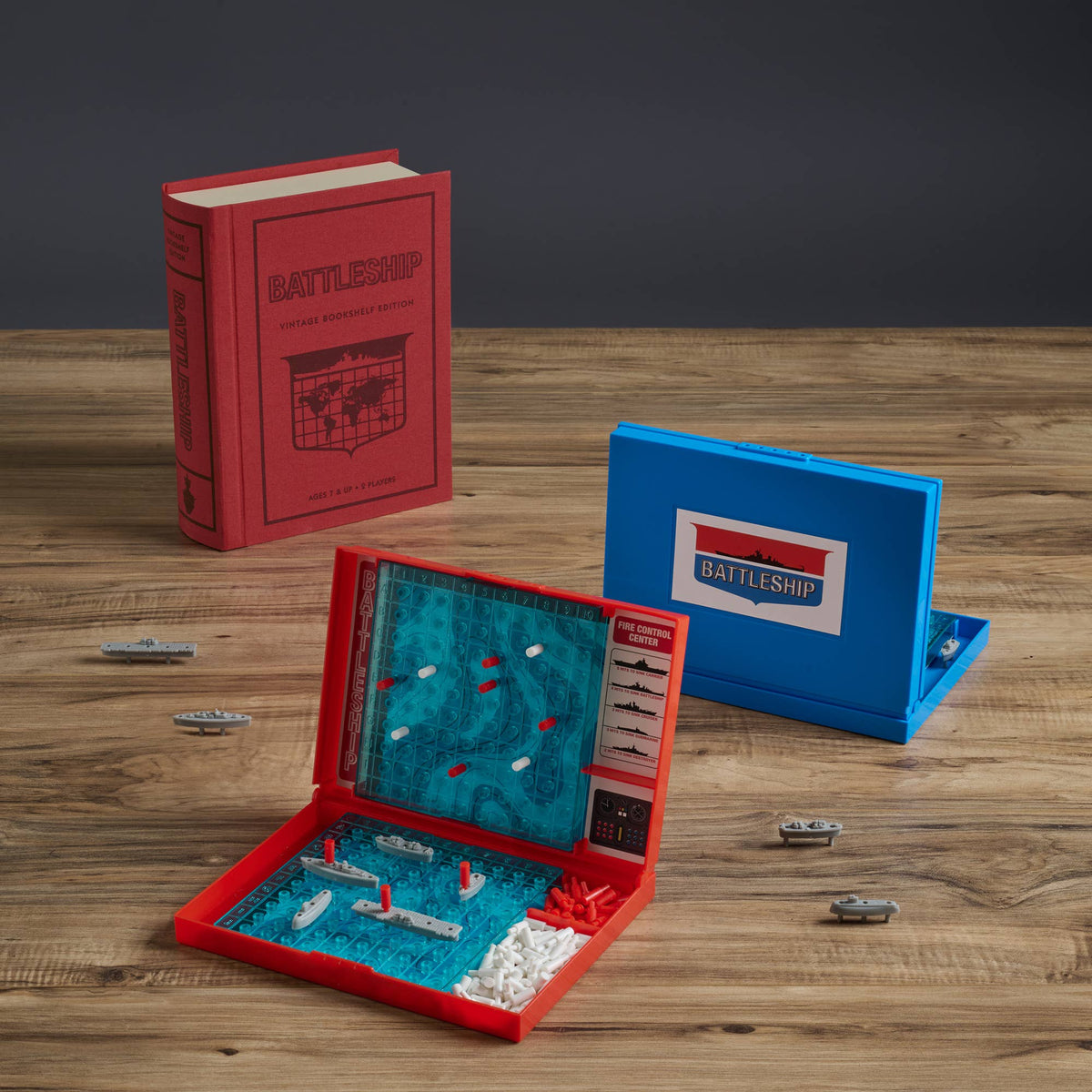 Open Battleship bookshelf edition with blue game board, instruction sheet, and metal ships