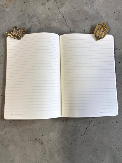 Set of 2 decorative metal page clips on an open notebook, gold-toned designs