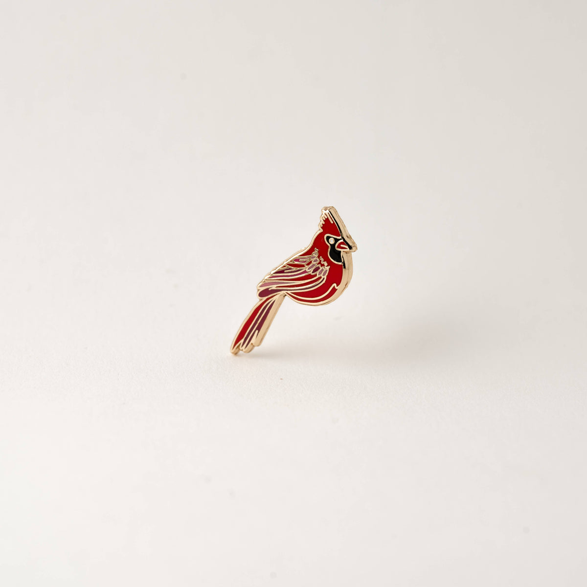 Red cardinal enamel lapel pin with gold-tone details