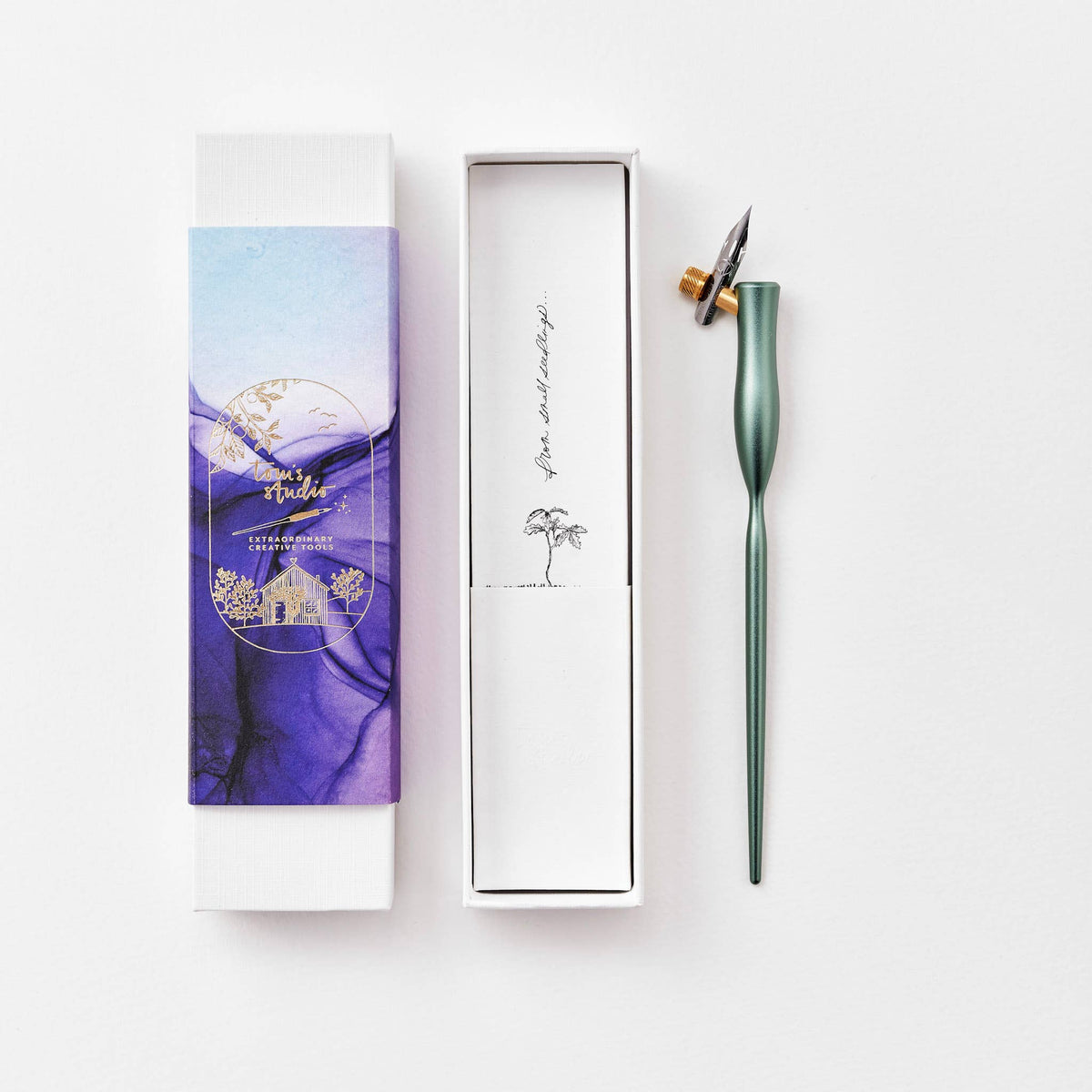 Dark green flourish calligraphy pen with angled nib and gold accent ring
