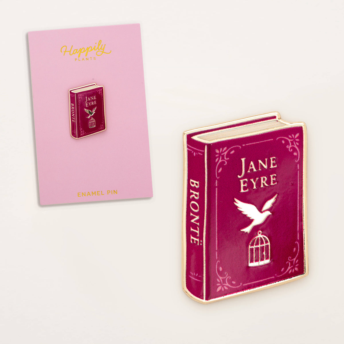 Enamel book pin with maroon Jane Eyre cover and gold border, featuring bird and cage