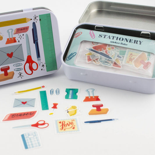 Stationery trinket tin open, showing sticker flakes in a clear inner tray