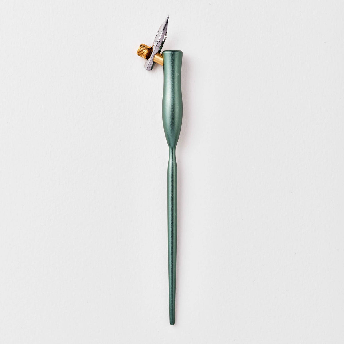 Green flourish calligraphy pen with angled nib and gold accent ring