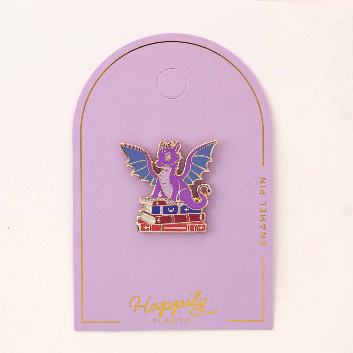Dragon book pin on purple backing card with gold border and hanger loop