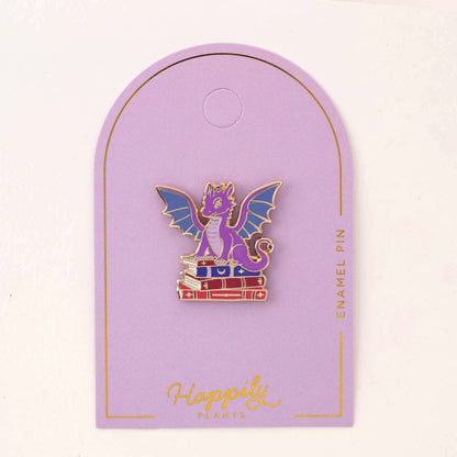 Dragon book pin on purple backing card with gold border and hanger loop