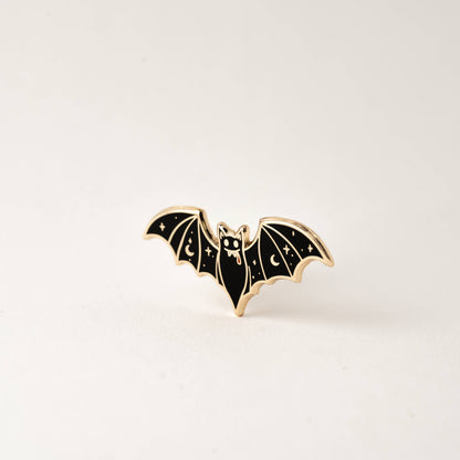 Vampire bat enamel lapel pin, three-quarter view with black wings and gold-tone frame