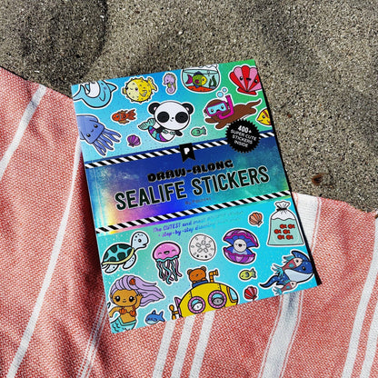 Sea life sticker book lying on fabric, front cover with underwater character illustrations