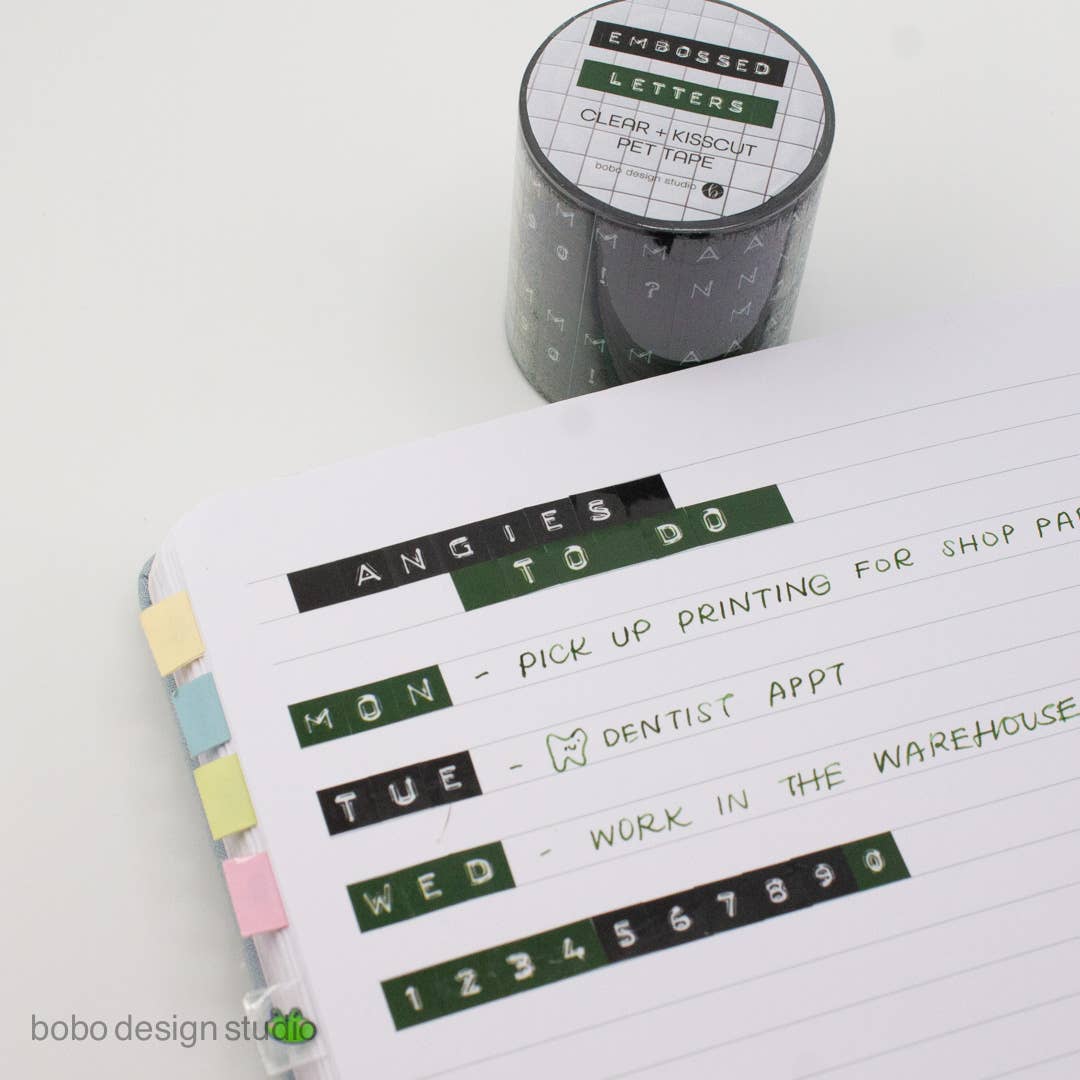 Black and green embossed letters PET tape roll with kiss-cut letter strips