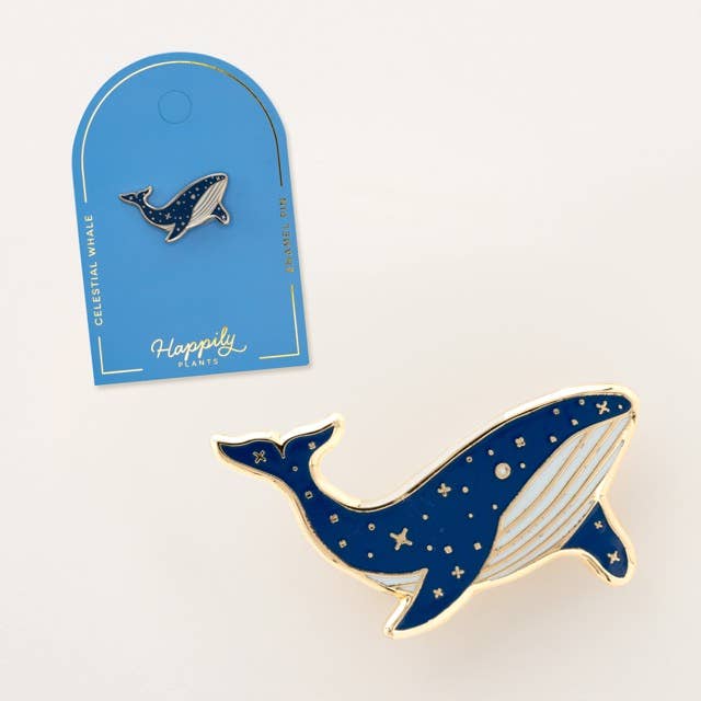 Blue whale enamel lapel pin in front of a “Happily” card backing