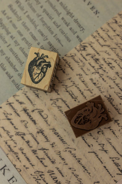 Set of two wooden stamps with carved fantasy animal designs on paper