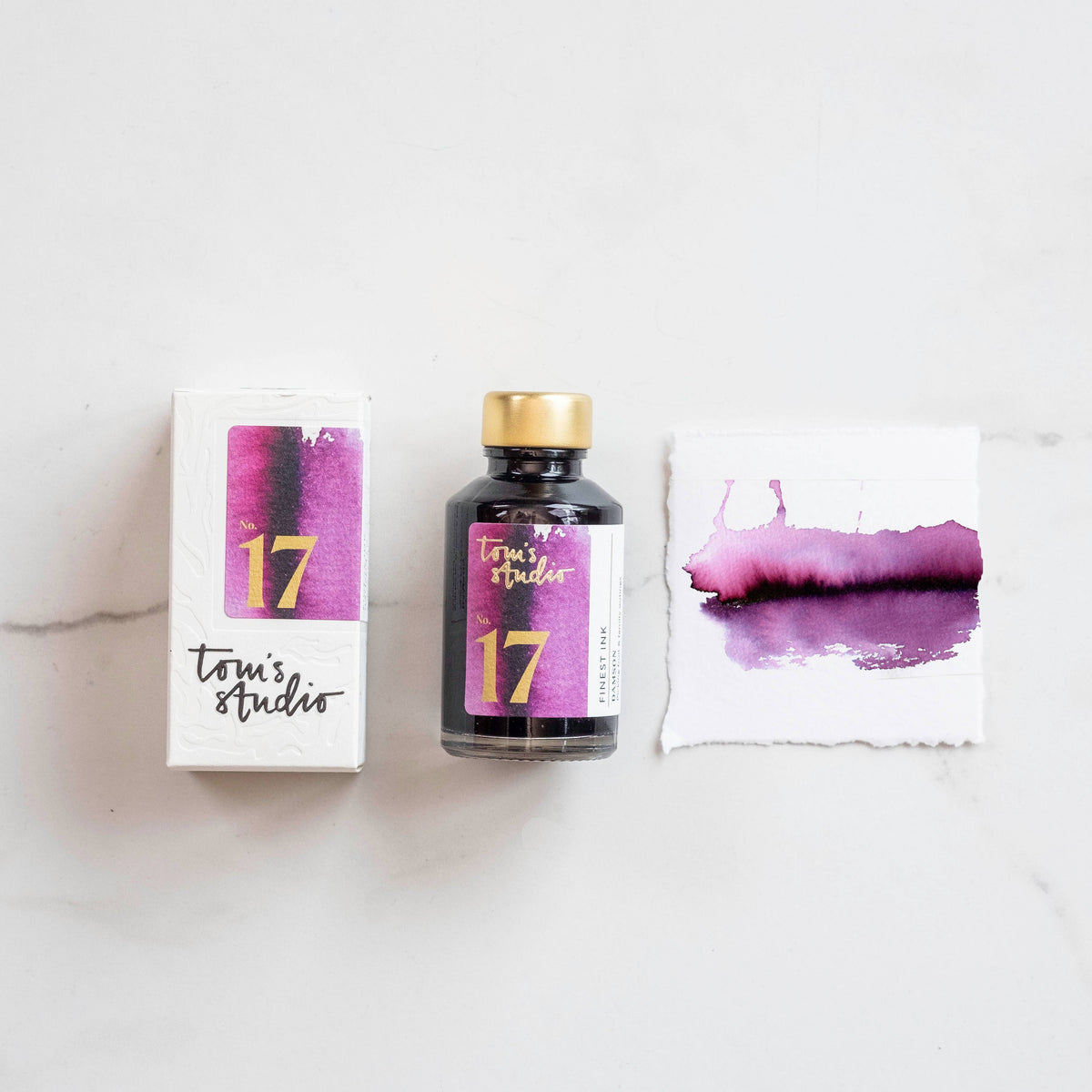 Damson fountain pen ink bottle with gold cap and plum ink swatch
