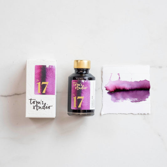 Damson fountain pen ink bottle with gold cap and plum ink swatch