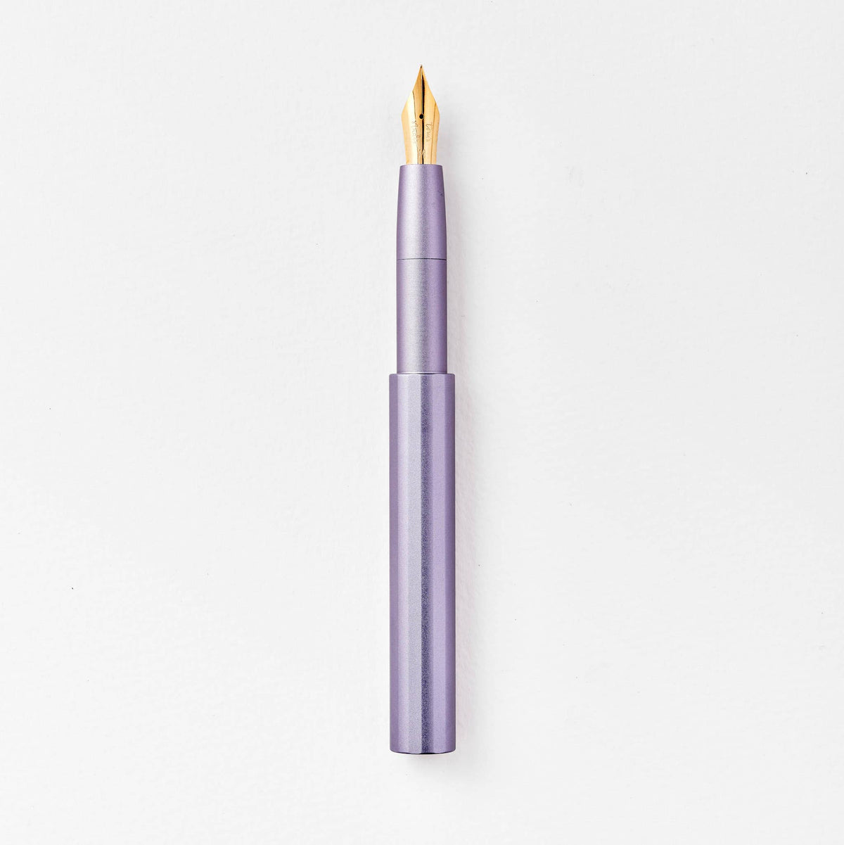 Lavender purple pocket fountain pen with gold nib, uncapped.