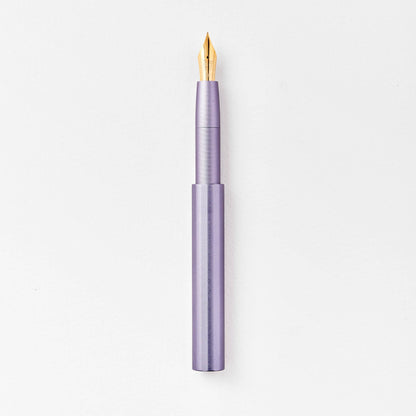 Lavender purple pocket fountain pen with gold nib, uncapped.