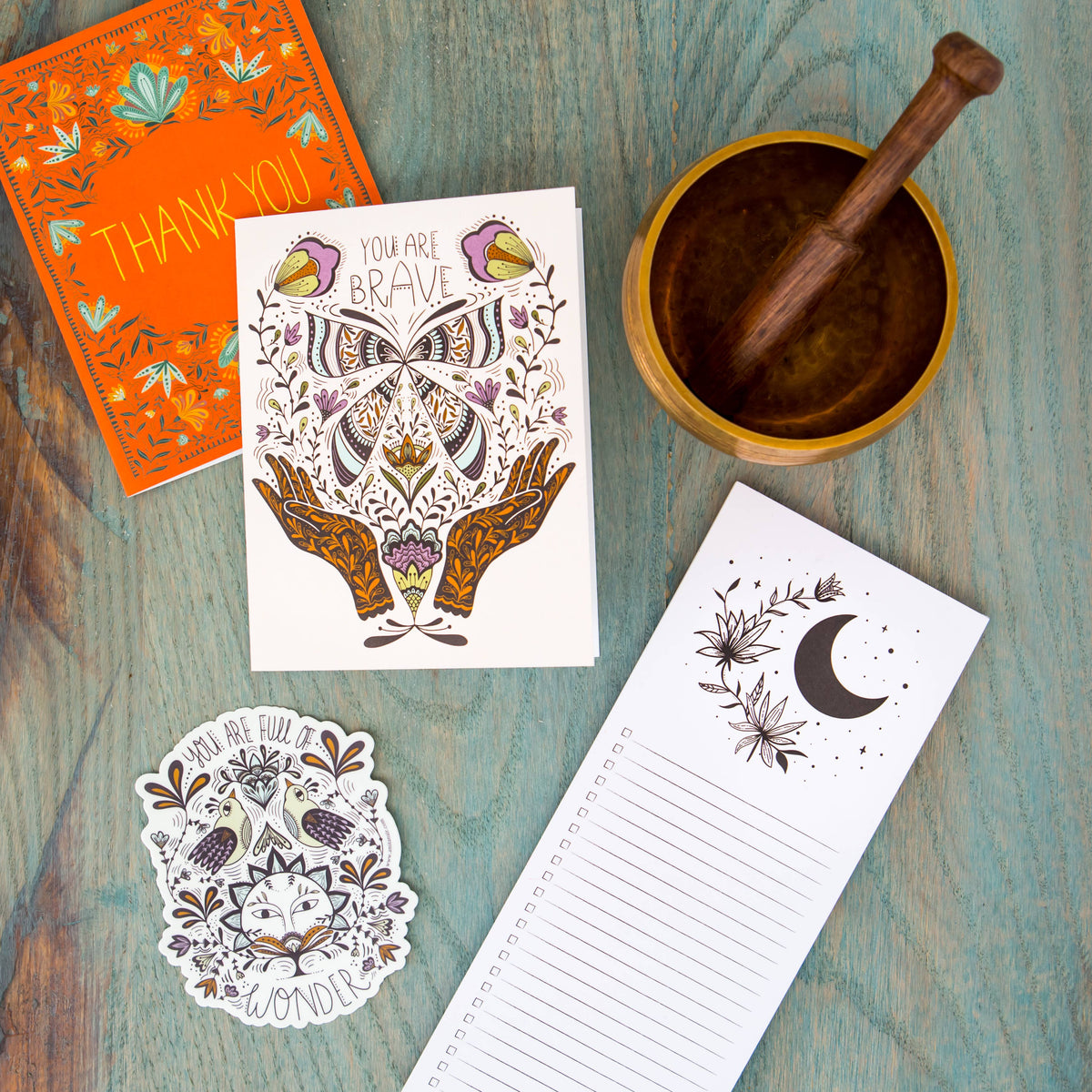 Greeting card with butterfly and hand illustration, shown with coordinating stationery.
