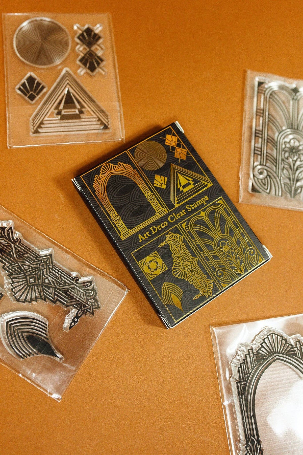 Clear stamp set featuring gold-toned art deco geometric patterns in separate blocks