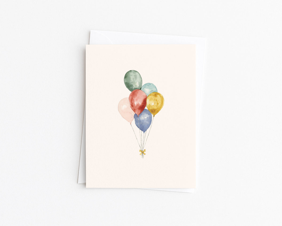 Greeting card with watercolor balloon cluster in green, teal, orange, and gold