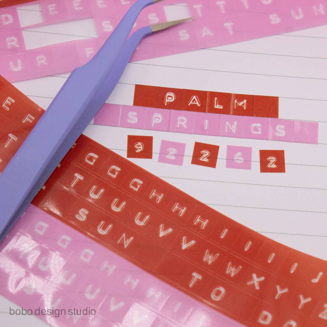 Set of embossed letter kiss-cut PET tapes in orange, pink, and purple with blocks