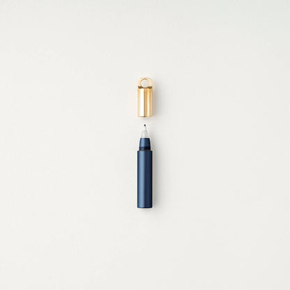 Midnight refillable travel pen with open gold cap and blue barrel tip