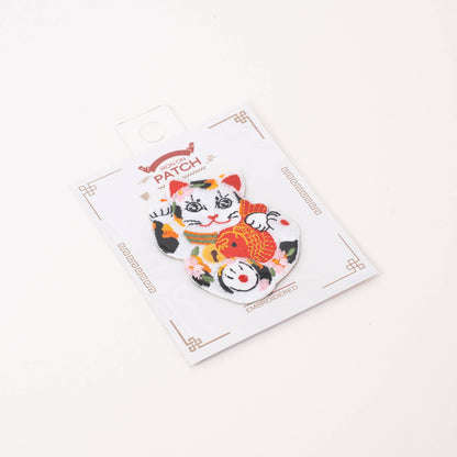 Lucky cat iron-on patch packaged on retail card