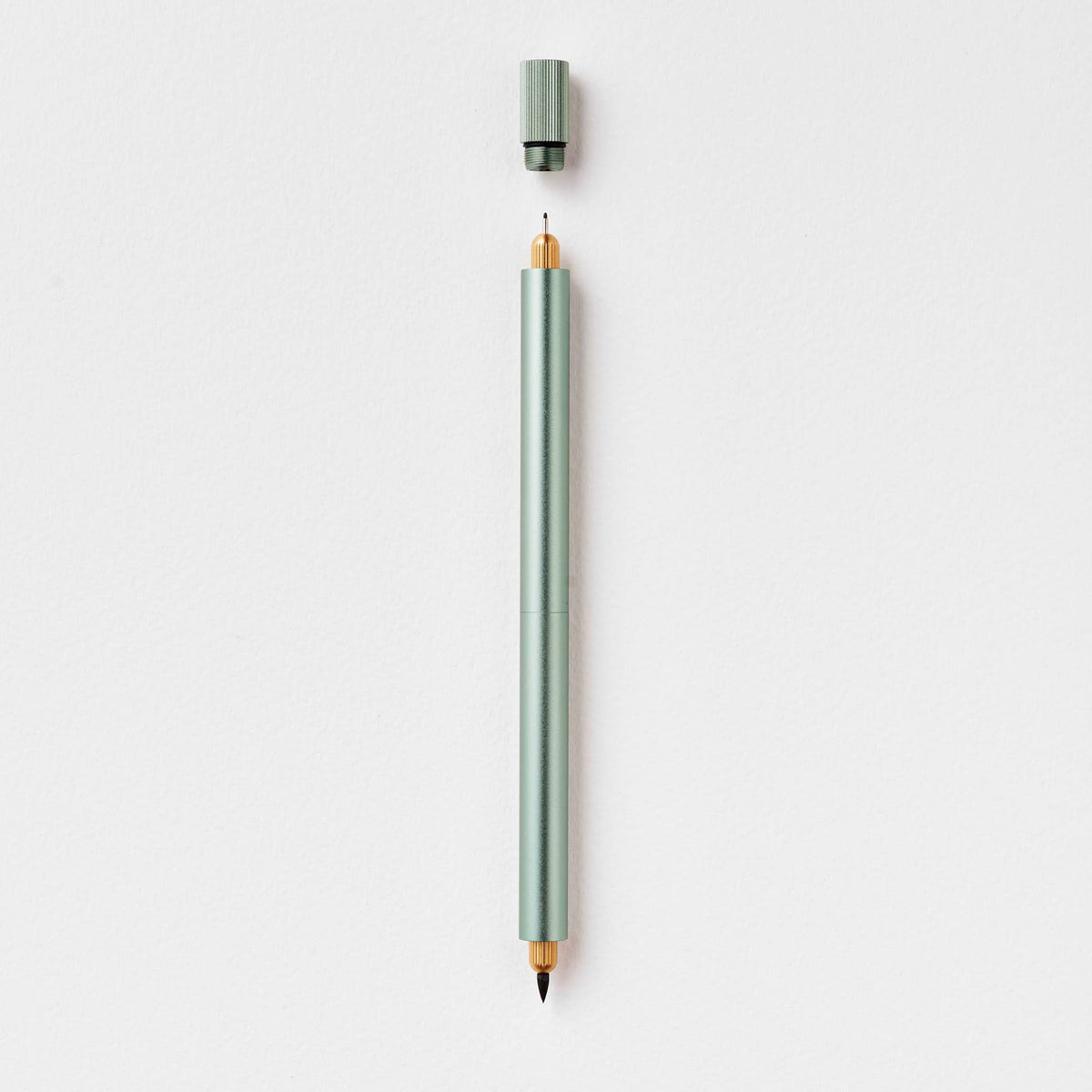 Sage green refillable multi-tip pen, capped, with gold-toned writing tip