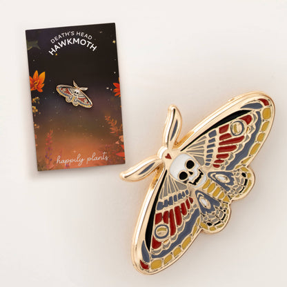 Gold-tone enamel death moth skull pin with red and blue wing details