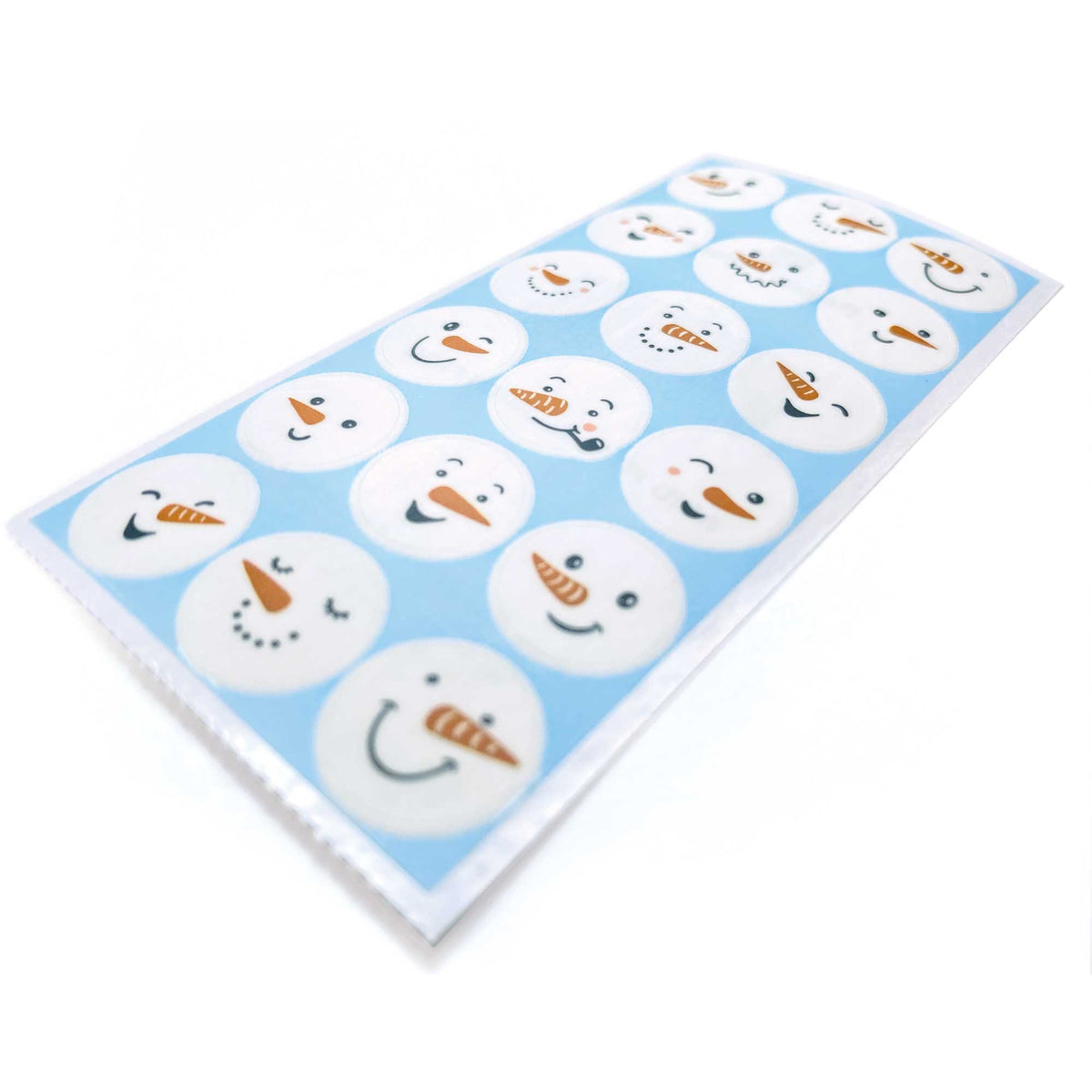 Snowman face sticker sheet with round smiling faces on light blue
