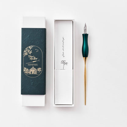 Calligraphy pen with oblique nib, teal handle, shown with gift box