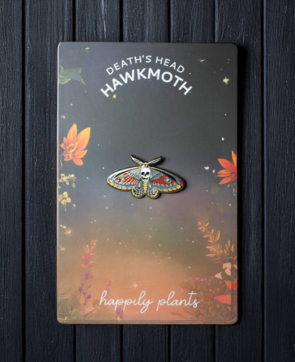Death moth skull pin card with illustrated moth emblem and gold-toned pin