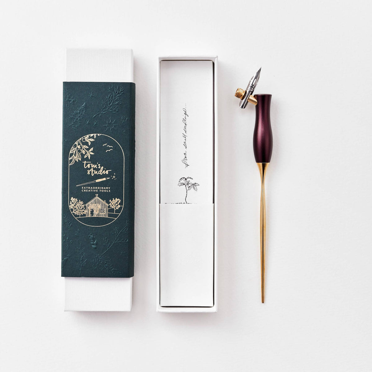Calligraphy pen with burgundy handle, gold nib, shown with gift box