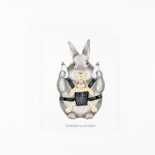 Greeting card with gray bunny parent holding baby bottles and “CONGRATULATIONS!”