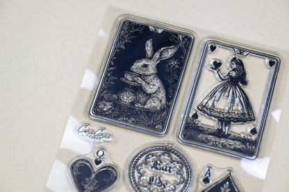Clear stamp sheet featuring rabbit and girl-in-dress motifs with card and charm icons