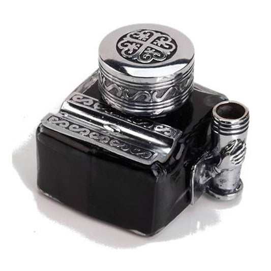 Decorative black ink inkwell with silver ornate cap, built-in pen rest and side pen holder