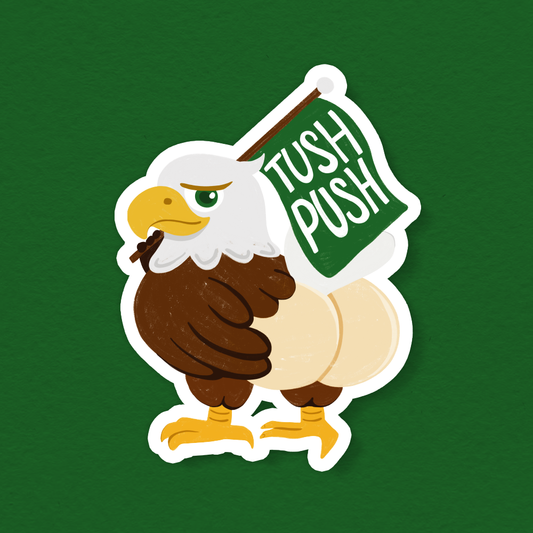Football vinyl sticker featuring a cartoon eagle holding a green “TUSH PUSH” sign